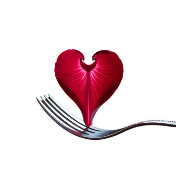 Naklejki Red heart shaped leaf on silver fork dark background romantic food art