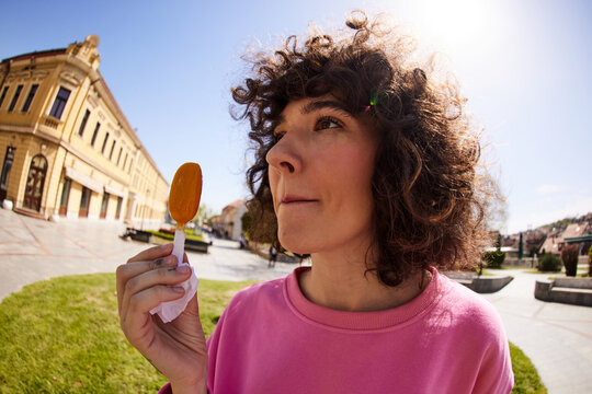 Woman munches on popsicle