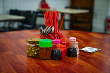 Hawker cutlery along with some sauces kept on a table