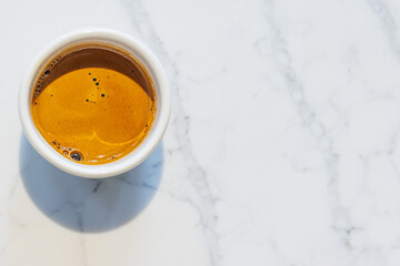 Freshly brewed espresso served in a small cup on a table