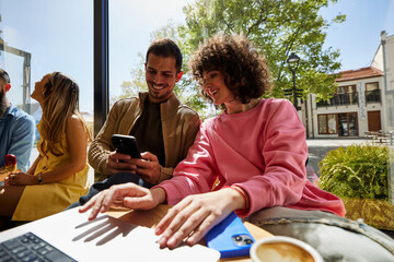 Happy people are working in a cafe