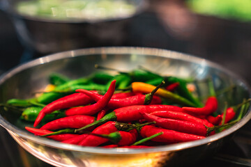 Red and green chillies close up mixed in one bowl
