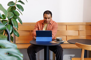 Man Using Tablet Work Session at Café Table
