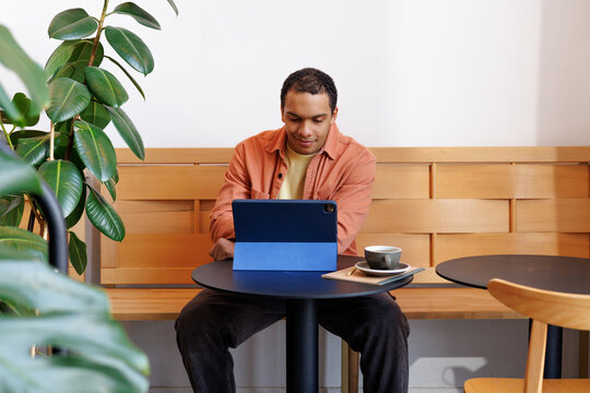 Man Using Tablet Work Session at Café Table