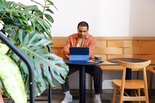 Remote Work Setup Man Working on Tablet in Caf&eacute;