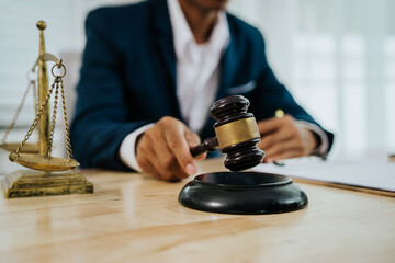 A lawyer consulting with a client in an office, reviewing legal documents and contracts related to justice, law, and business.