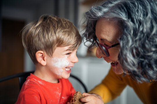 Grandmother sharing a loving moment with grandson while baking