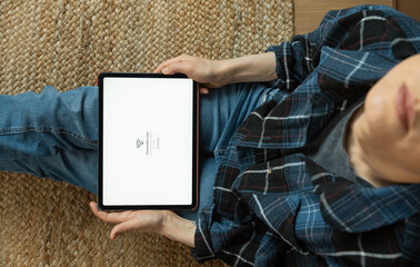 Frustrated freelancer struggling with internet connection on tablet