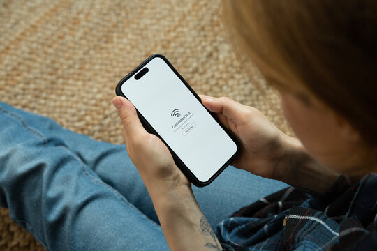 Woman having problem with wifi connection on mobile phone - Powered by Adobe