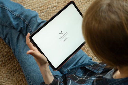 Woman holding tablet showing connection lost message
