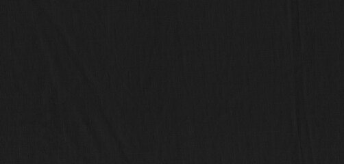 Black cotton or linen fabric sample for background. Close-up of a smooth, slightly reflective black fabric showcasing its texture and subtle lighting highlights, creating an elegant