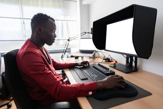 Video editor working from home using professional monitor