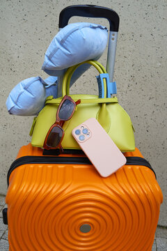 Brightly colored luggage with travel essentials