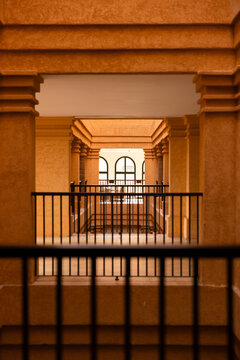 Naklejki Symmetrical view through architectural hallway arches