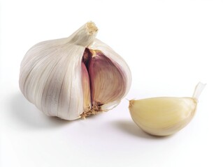 Whole garlic bulb and single garlic clove on white background
