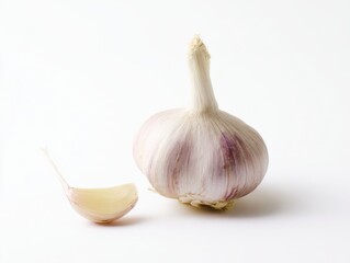 Whole garlic bulb and single garlic clove on white background
