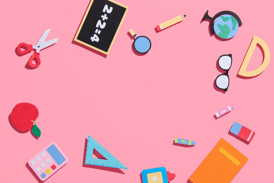 school supplies at colorful paper background