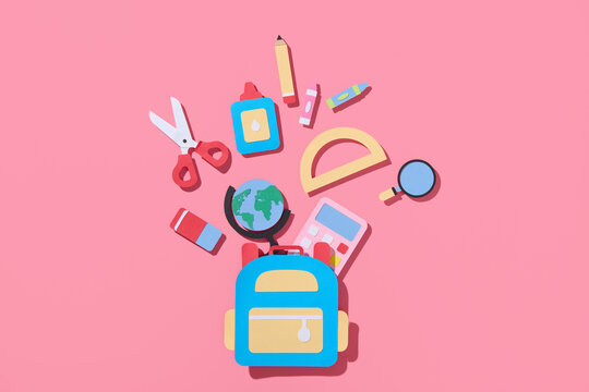 Flat lay frame composition from school supplies on pink background