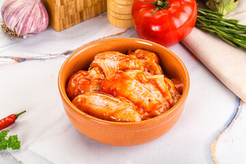 Raw marinated uncooked chicken wings