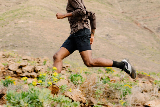 Unknown runner moves across irregular ground during a fit routine