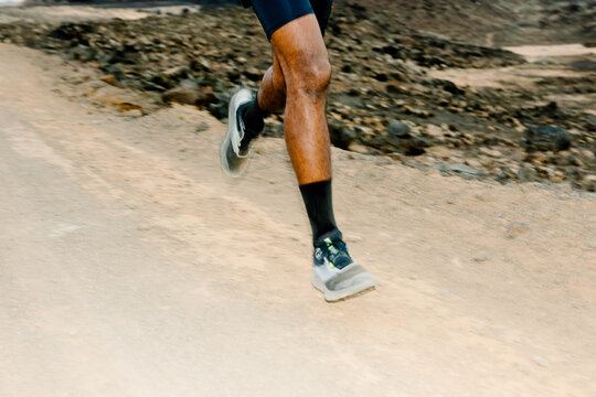 Medium shot with flash of an unknown man running on a dusty trail