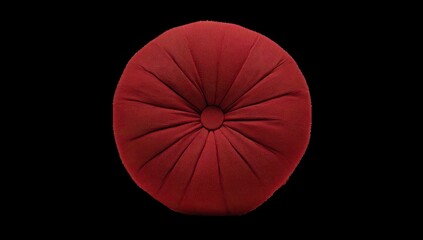 Red round cushion on black background
