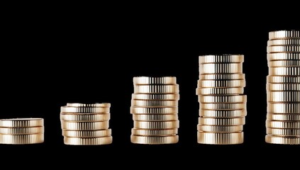 Gold coins stacked in increasing heights on black background