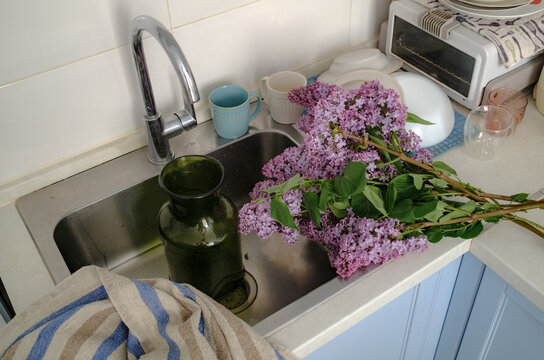 
a bouquet of lilacs lies on the kitchen table