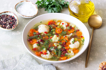 Vegetable soup with cauliflower, beans, carrots and zucchini. Healthy eating. Vegetarian food.
