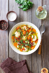 Vegetable soup with cauliflower, beans, carrots and zucchini. Healthy eating. Vegetarian food.