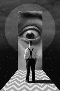 A man stands in front of a giant eye