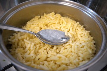 Goose throat pasta in the pot with spoon