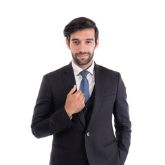 Confident young businessman in formal black suit and blue tie adjusting his outfit, standing professionally and isolated on a transparent background, corporate executive portrait concept