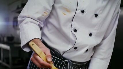 Chef in motion: stirring in a professional kitchen with dynamic action and energy.