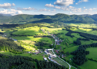 Panoramic view of a picturesque valley in the morning light, fog, meadows and morning light, spring rural landscape