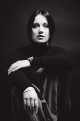 Portrait of a woman with dark hair, done in low key style.