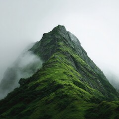 A verdant mountain peak shrouded in mist, its rugged slopes gradually descending into a sea of fog, creating a serene and mysterious atmosphere