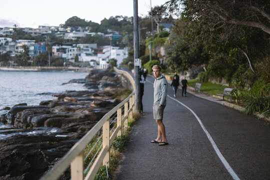 Man standing on balmoral beach coastal walk in sydney, australia