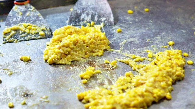 Jagung keju tarik (pulled cheese corn). Steam corn mixed with cheese. Indonesian modern street food.