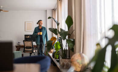 Senior man enjoying coffee in a bright living room