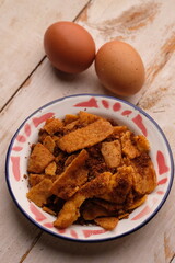 Crispy egg rendang on a plate. Indonesian food originating from West Sumatra. Rending telur.