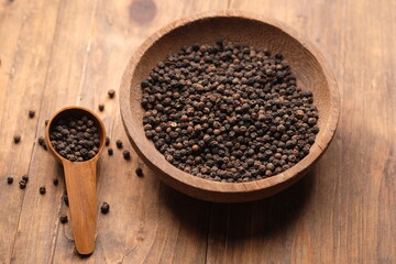 black pepper in a wooden bowl. Pepper, which has the Latin name Piper nigrum, is a plant that is rich in chemical content, such as pepper oil, fatty oil, and starch.