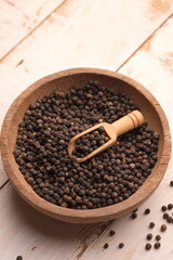 black pepper in a wooden bowl. Pepper, which has the Latin name Piper nigrum, is a plant that is rich in chemical content, such as pepper oil, fatty oil, and starch.
