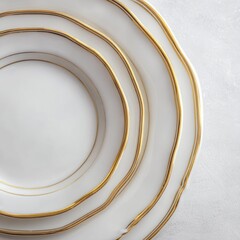 Stacked white dinner plates with gold trim