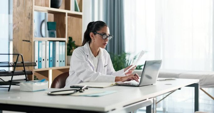 Doctor, woman and laptop with document in clinic for medical journal, research or telehealth. Healthcare, report or typing with paperwork in hospital for administration, management or problem solving