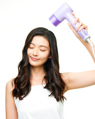 Asian girl using hair dryer