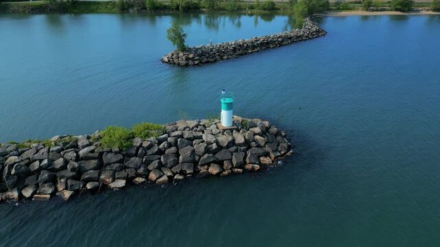 4K Drone Reveal Shot of Jordan Harbour Breakwater Light and 401 Highway in Ontario