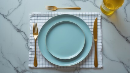 Empty blue plate with cutlery and napkin on light grey marble table, overhead view