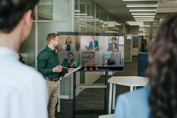 Business team discussing strategy during an online conference in a coworking office