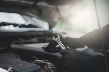 Auto mechanic working in a garage. Auto mechanic technician working in a garage. Service and maintenance. Car inspection.